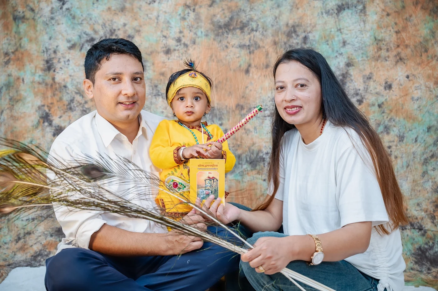 Family portrait with a toddler dressed as Krishna for a Janmashtami-themed photoshoot